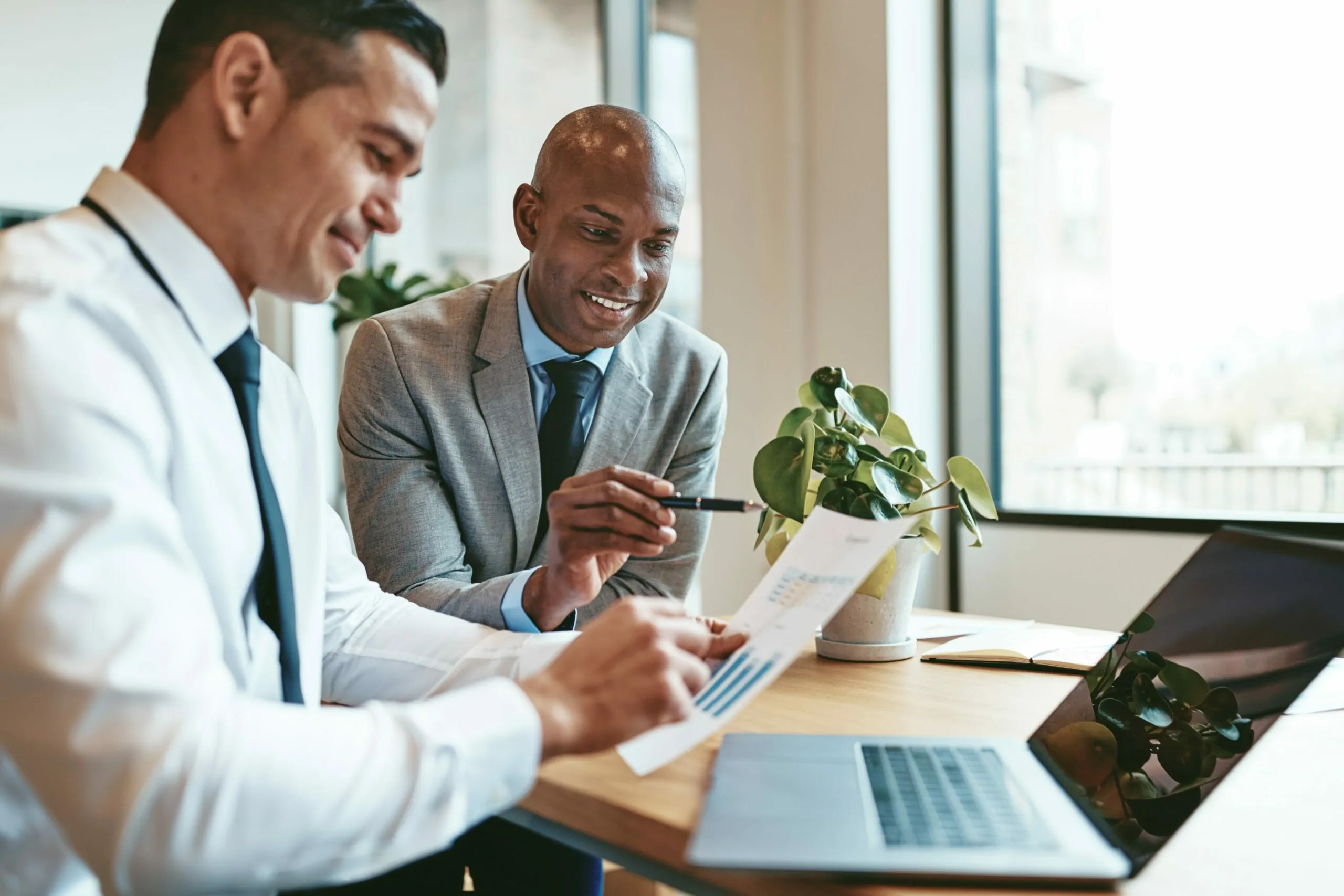 Two men looking at a computer screen