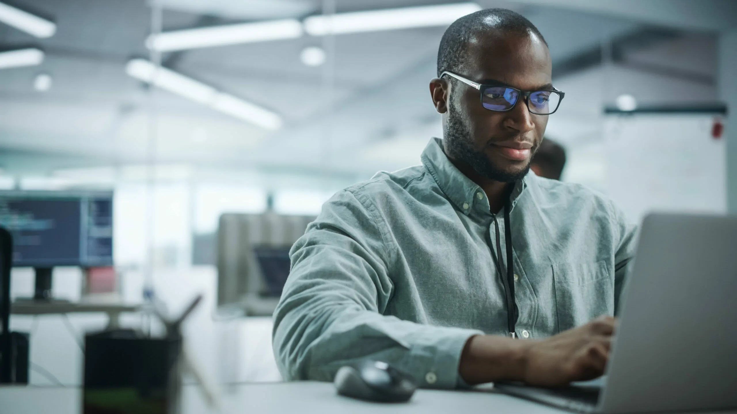 Professional man working on a laptop viewing vendor relationship management software